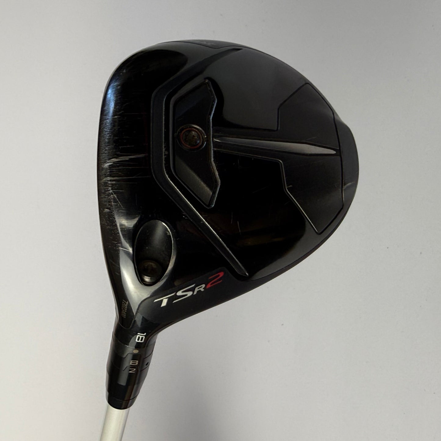 Titleist golf club head with 'TSR' branding on a light gray background