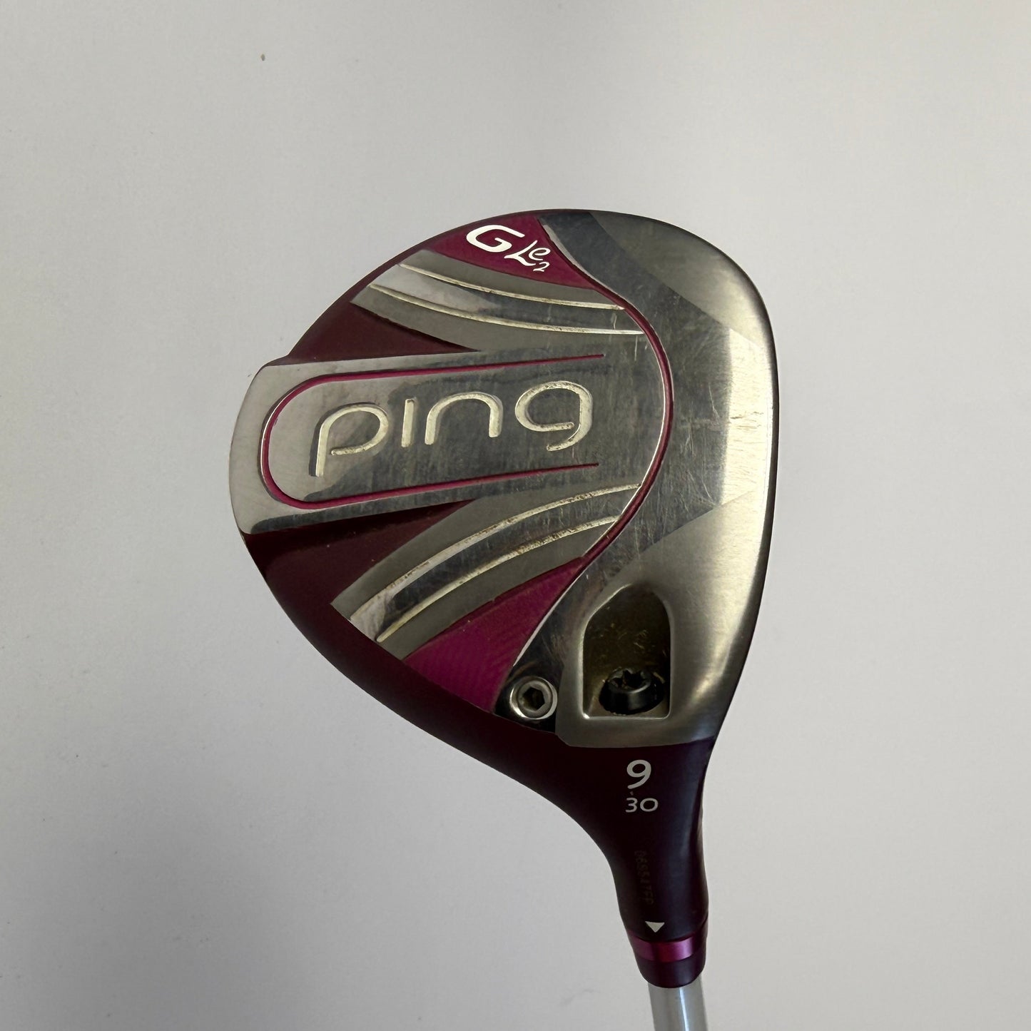Ping branded fairway wood golf club with GLE2 on the sole on a grey background