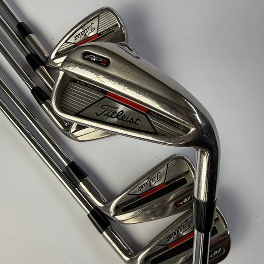 Set of golf clubs with Titleist AP1 branding on a white background