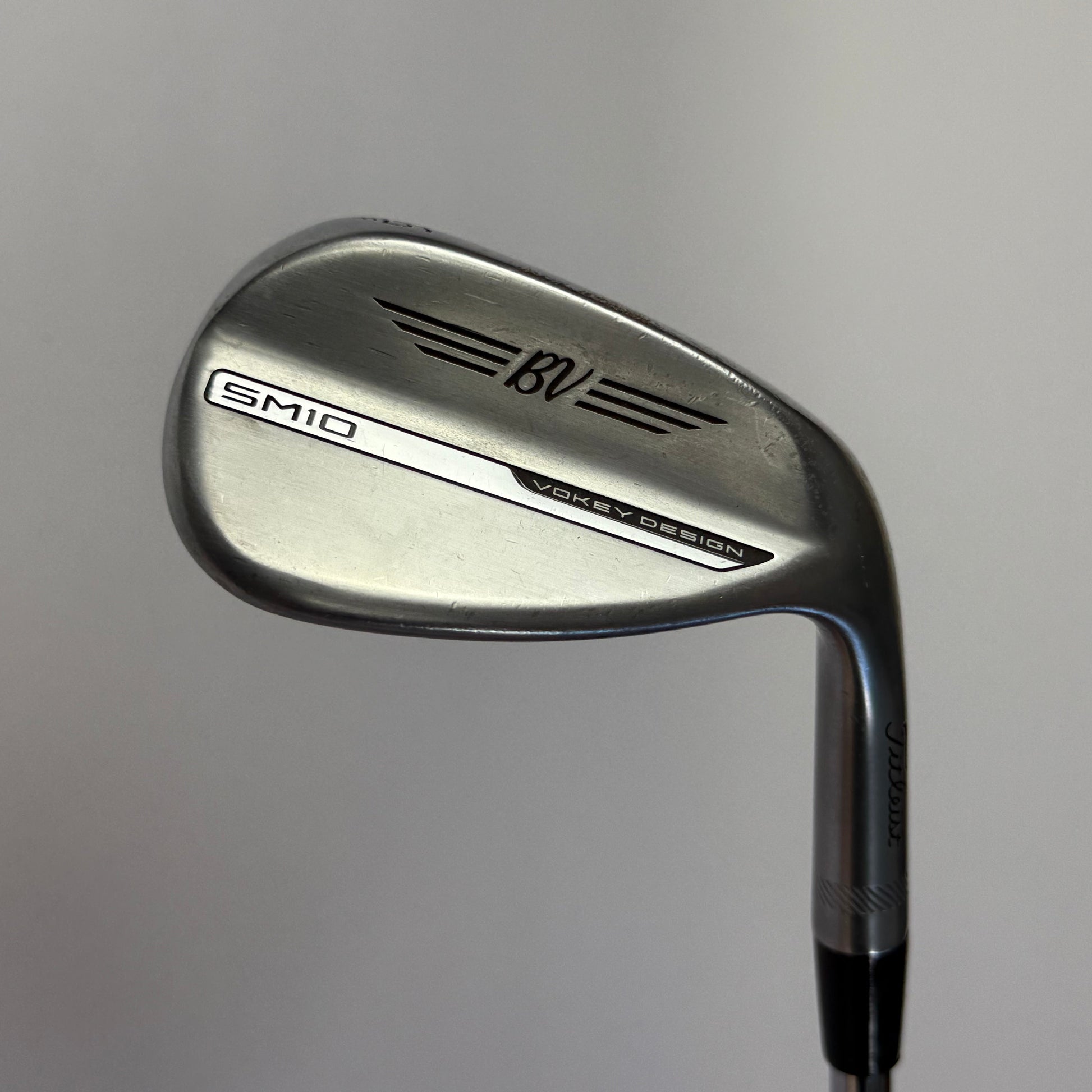 Titleist Vokey SM10 Wedge golf club on a gray background