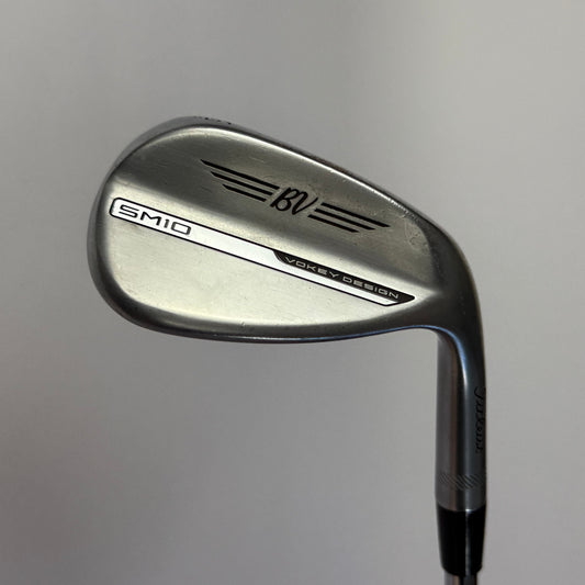Titleist Vokey SM10 Wedge golf club on a gray background