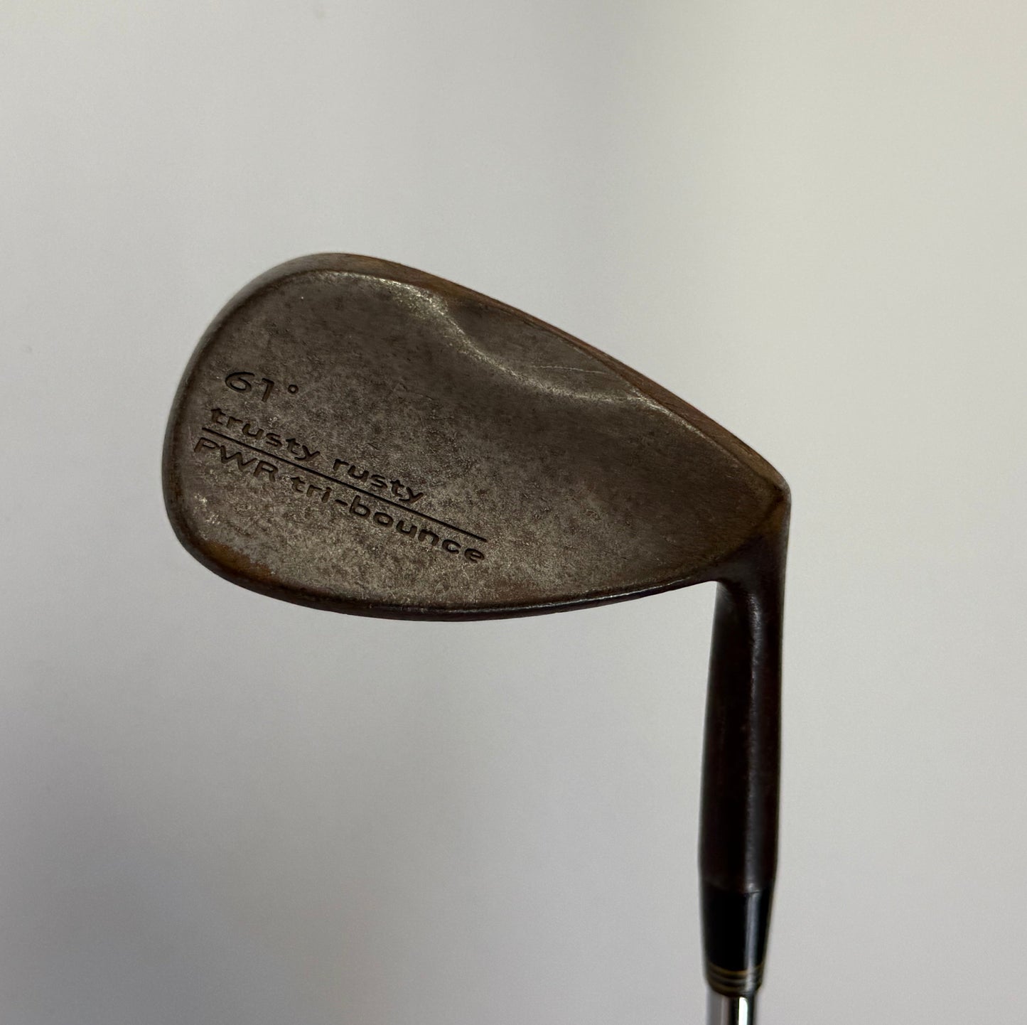 Cobra Trusty Rusty Wedge Golf club on a light gray background
