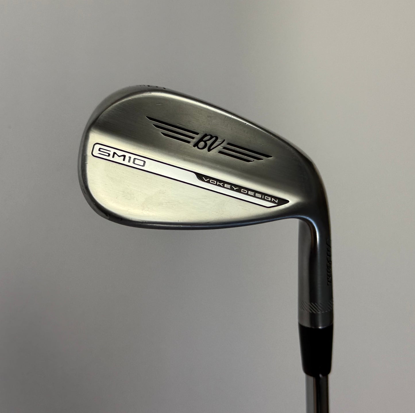 Titleist Vokey SM10 Wedge Golf club  on a gray background