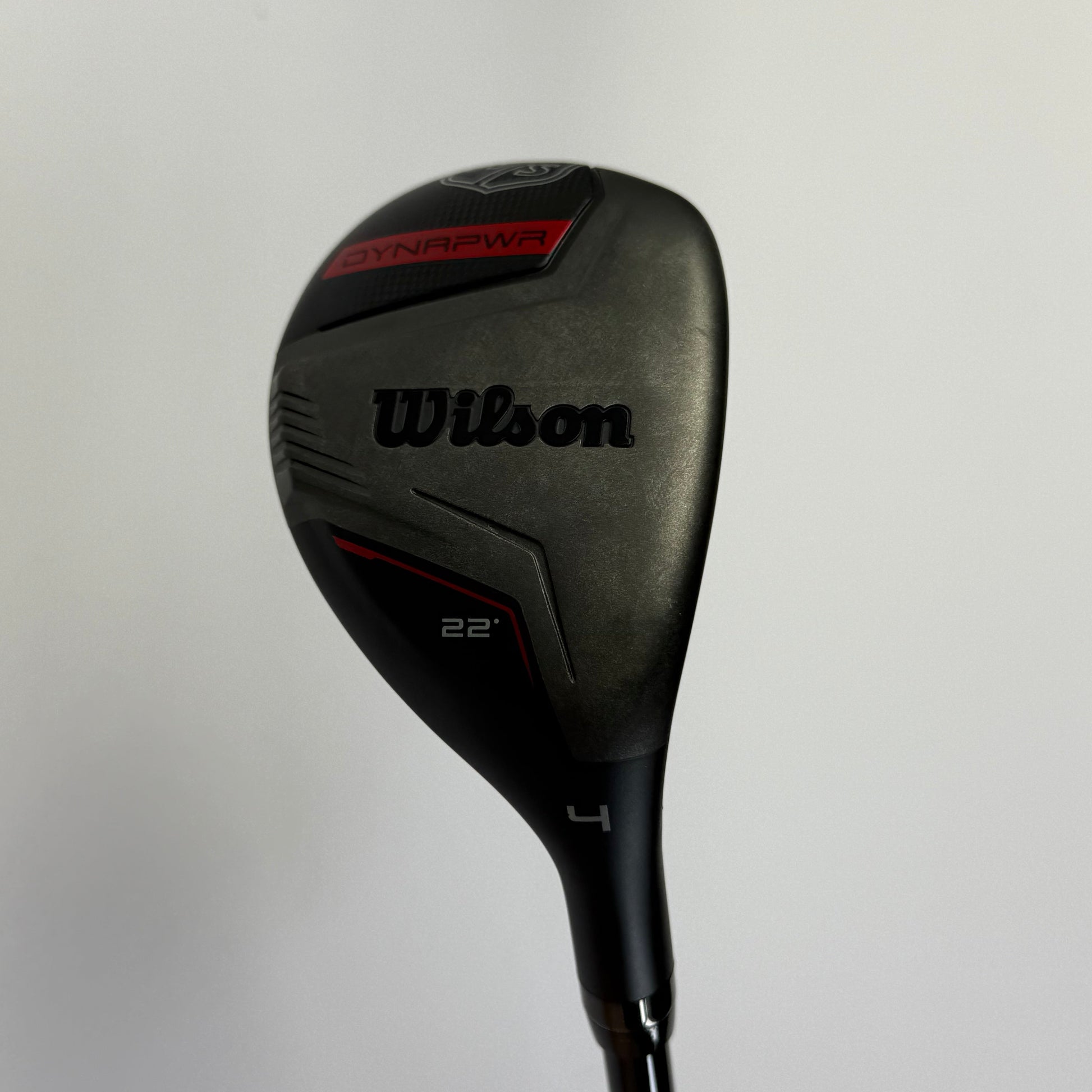 Hybrid golf club with 'Wilson Staff Dynapower' branding on a light gray background
