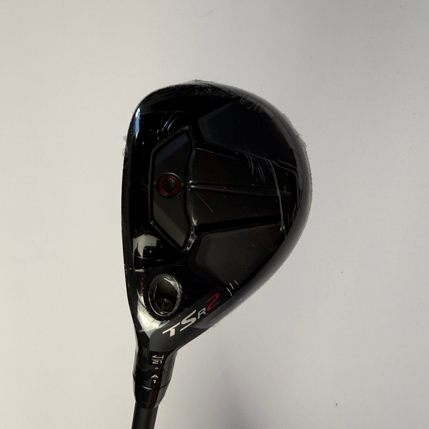 Hybrid golf club head with 'Titleist TSR2' branding on a light gray background