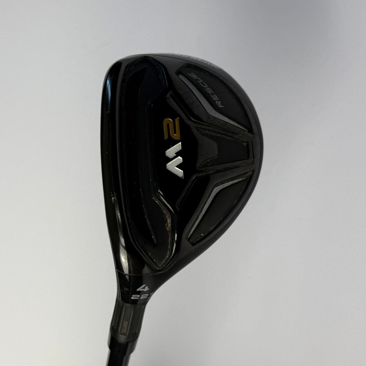 Taylormade M2 hybrid golf club on a gray background