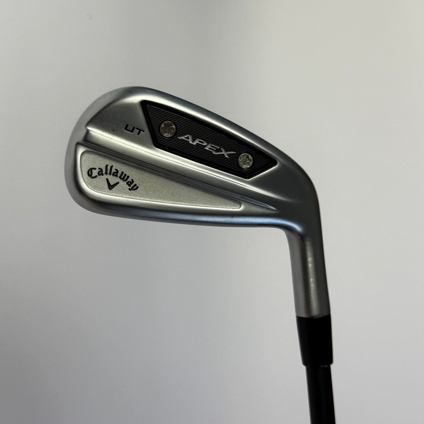 Golf club (driving iron) with Callaway Apex branding on a gray background
