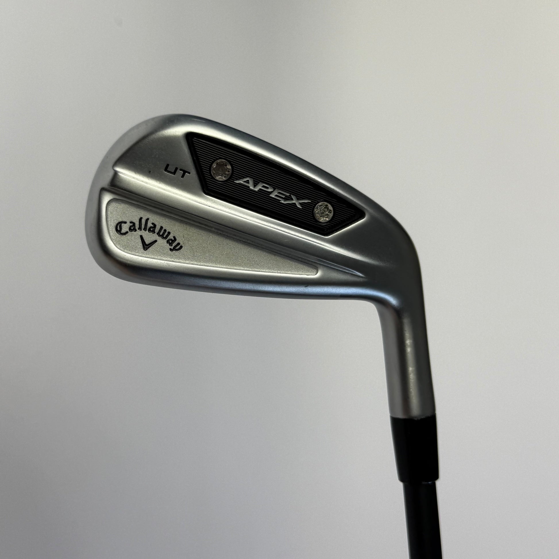 Golf club (driving iron) with Callaway Apex branding on a gray background