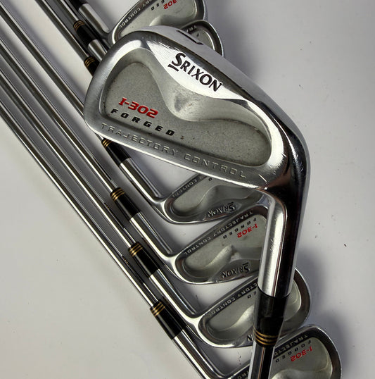 Set of Srixon I-302 Forged iron golf clubs on a white background