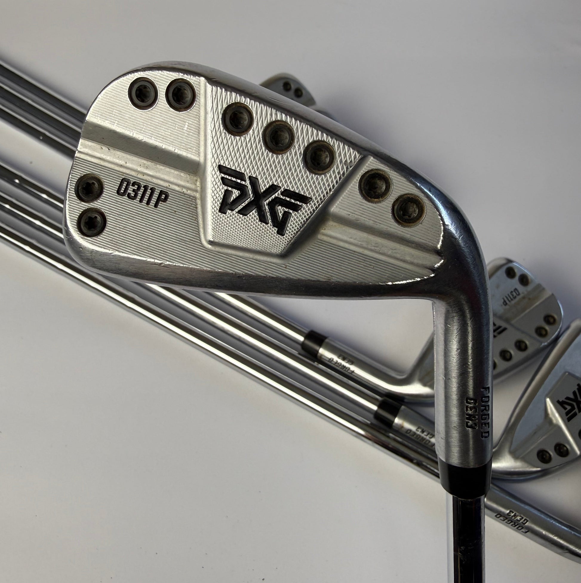 PXG 0311P Gen 3 irons on a white background