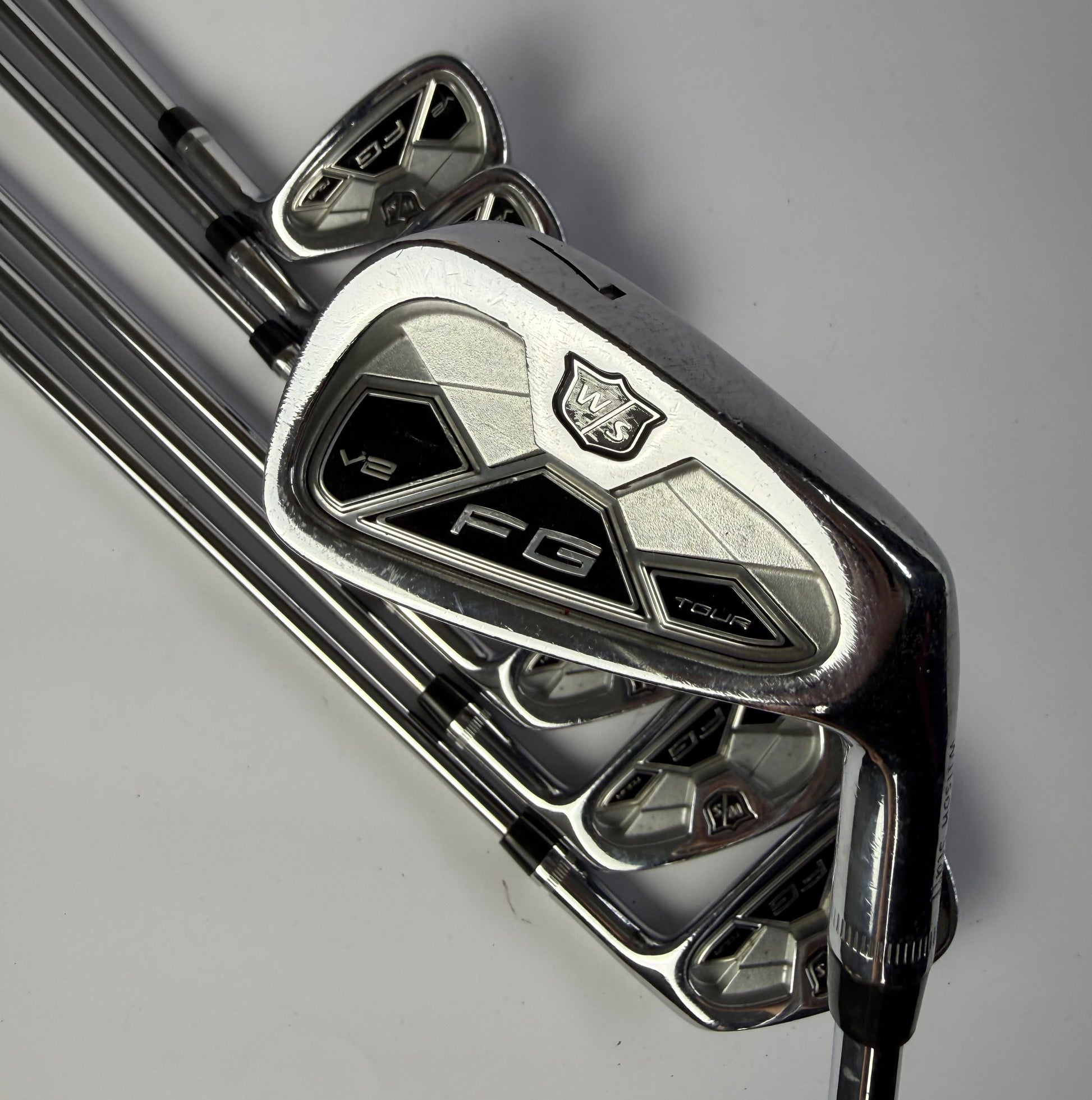 Wilson Staff FG Tour Irons on a gray background