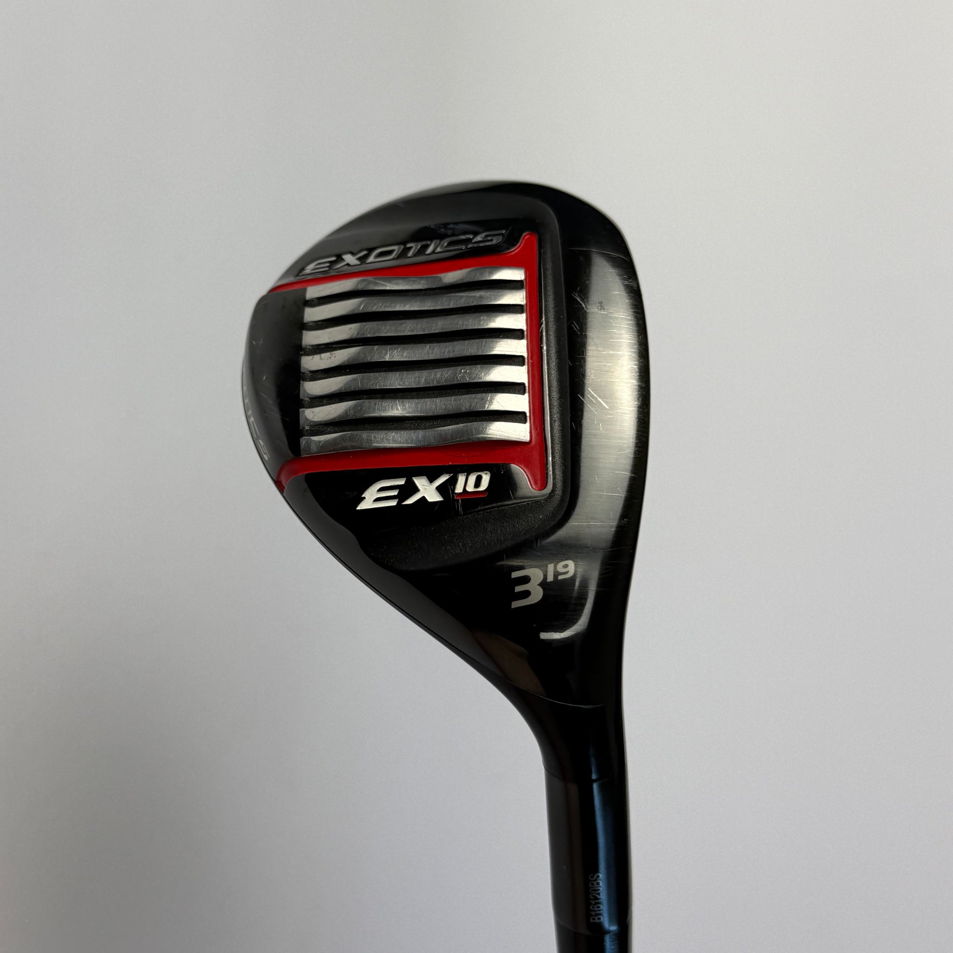 Hybrid golf club with 'Exotics EX10' branding on a gray background