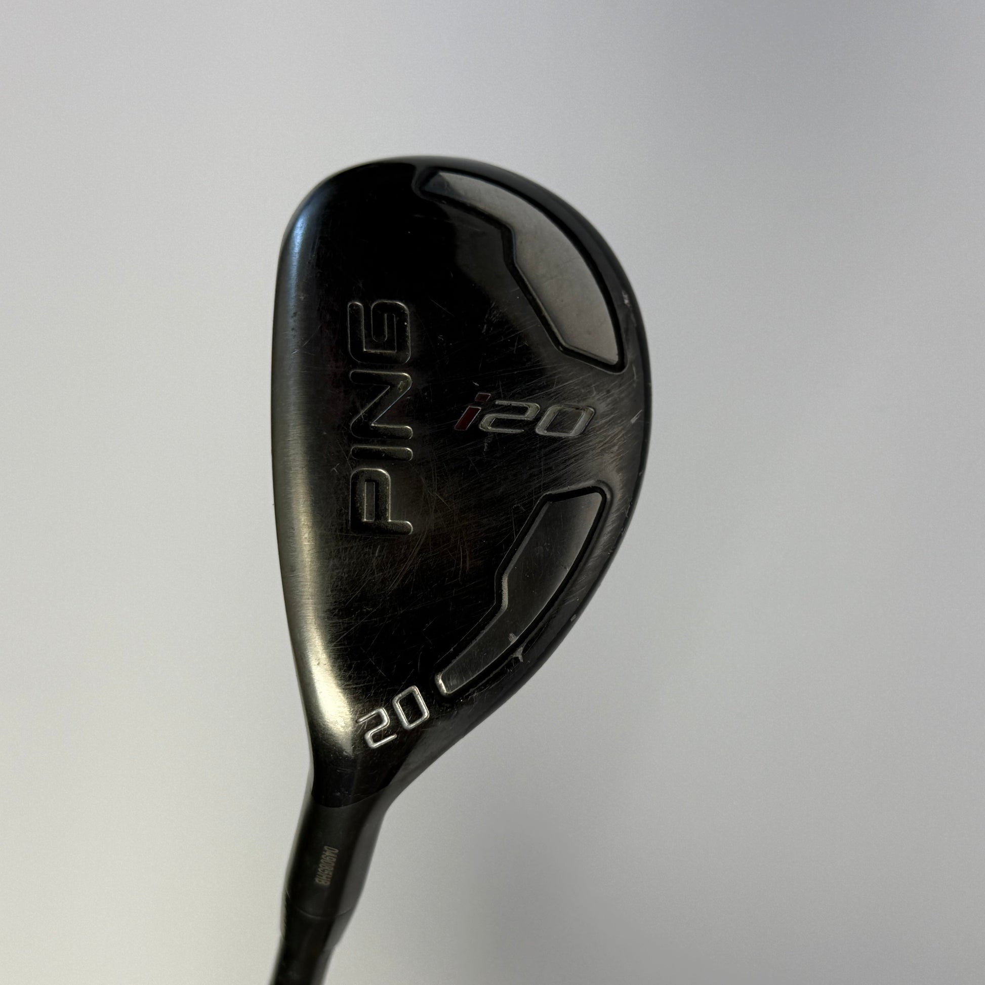 Hybrid golf club with 'PING' branding on a light gray background
